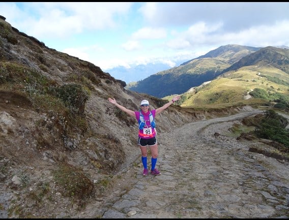 a person posing on a rocky trail