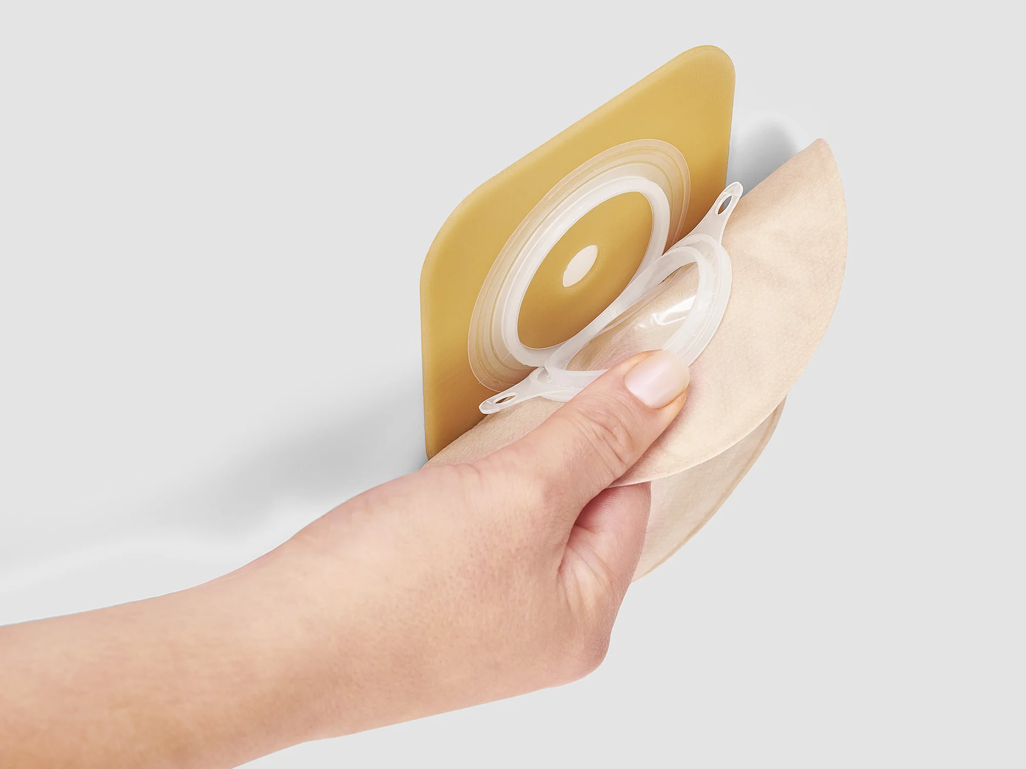 a hand holding a yellow cup