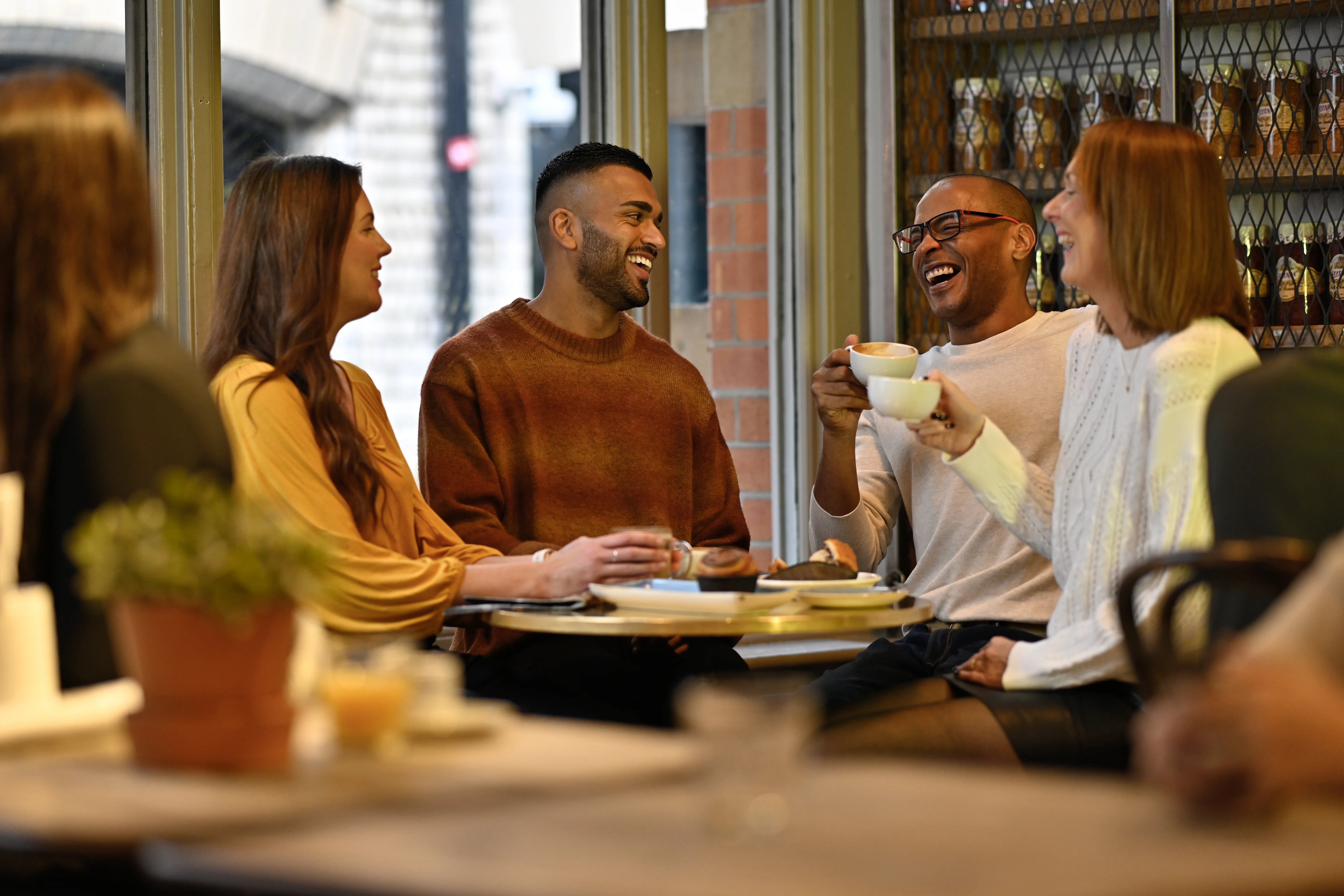 a group of people sitting at a table with food